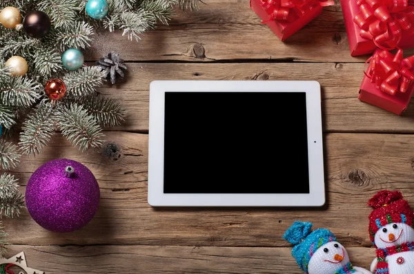 White tablet computer with branch Christmas tree and Christmas p