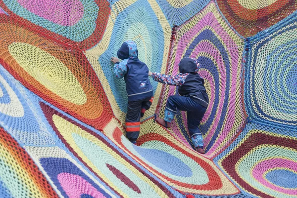 Two children playing in climbing