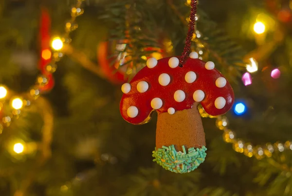 Gingerbread mushroom as a Christmas decoration hung on the Christmas tree