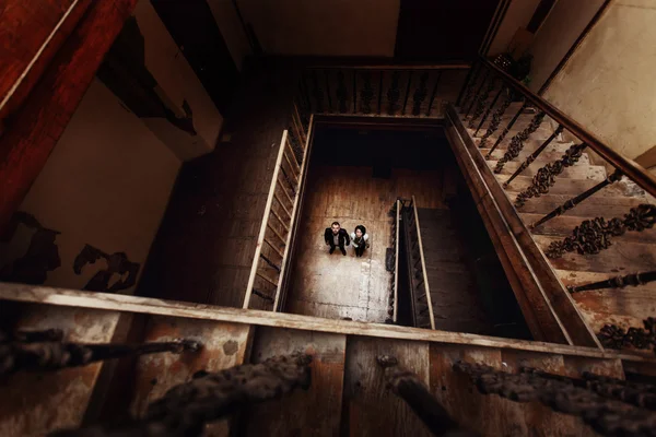 Couple hugging on rustic wooden staircase