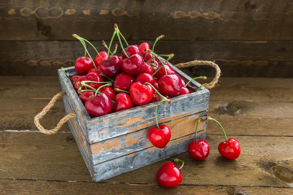 Cherries with water drops is in vintage wooden box