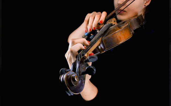 Woman\'s hands playing the violin