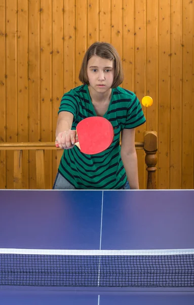 Girl playing table tennis with a cat