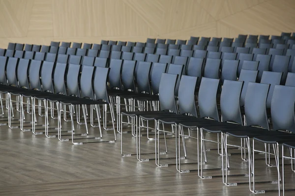 Rows of empty chairs prepared for an indoor event