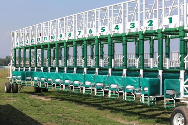 Horse track with starting gates at a race track summertime