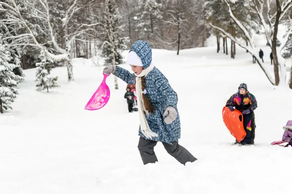 Children Sliding on Snow Slides in Russian Winter