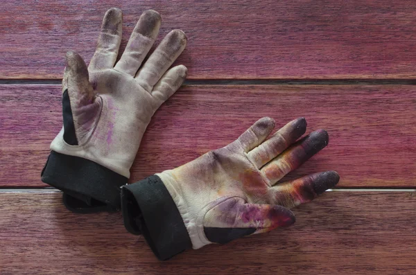 A pair of stained work gloves
