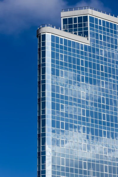 The glass facade of a tall building