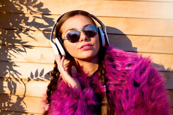 Pretty young woman listens music