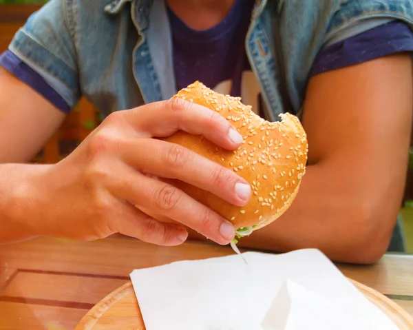 Happy young man with a big hamburger