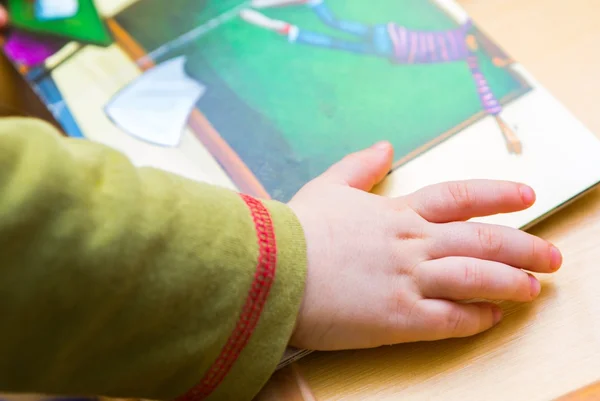 Small boy watching illustrated book