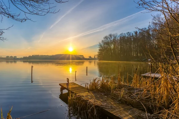 Sunrise over lake at end of winter