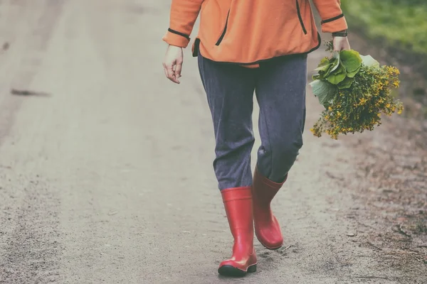 Caucasian woman with wild herbs bouquet