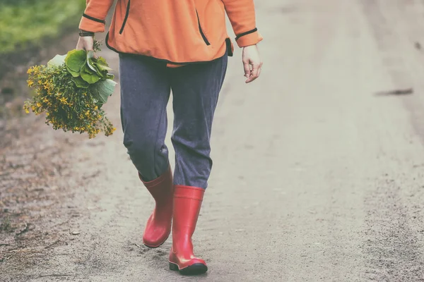 Caucasian woman with wild herbs bouquet