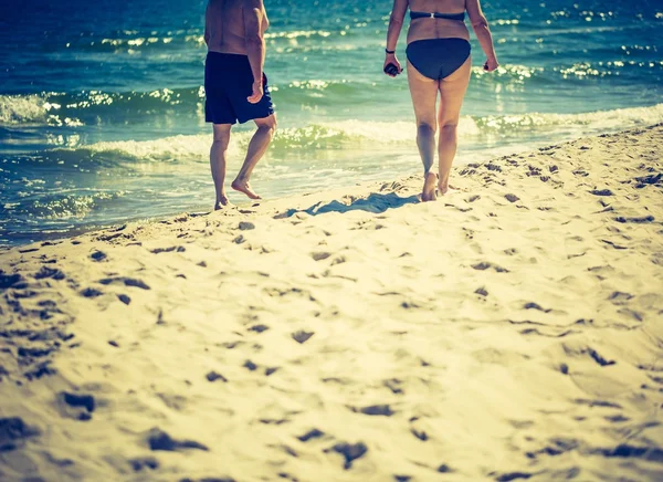 Couple walking by sea shore