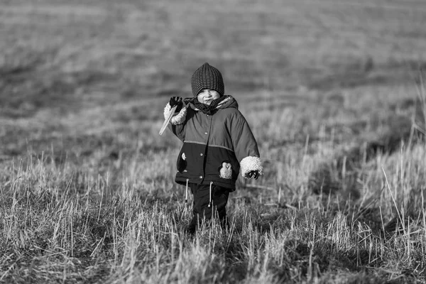Young happy boy playing outdoor at spring. Black and white