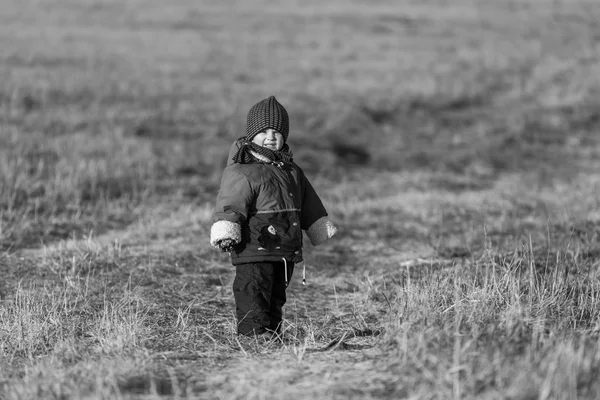 Young happy boy playing outdoor at spring. Black and white