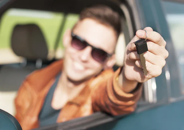 Young man showing car keys - Stock Image