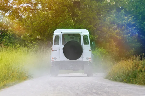 Off-road vehicle on the ground and rainbow