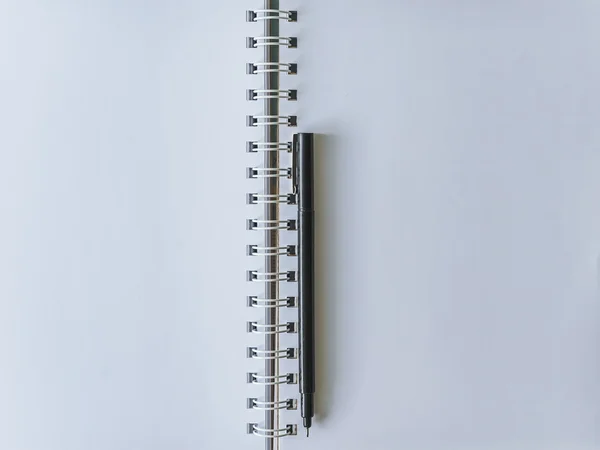 White Notebook blank cover with pen.