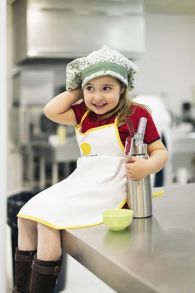 Happy sweet girl cooking.