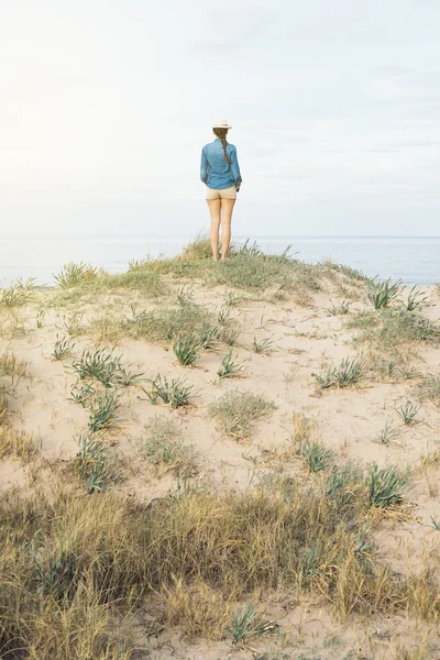 Woman walking away on the idylic beach.