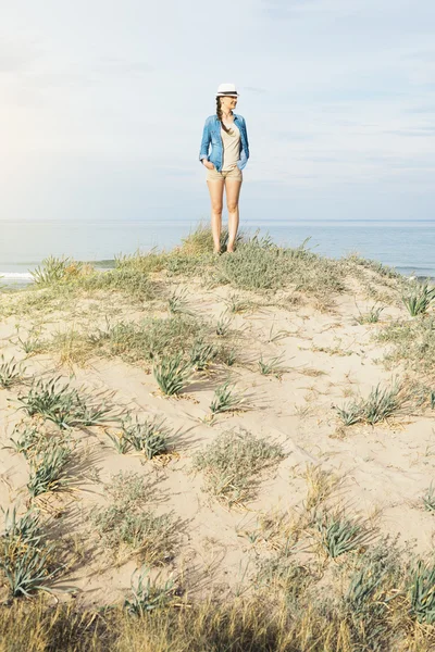 Woman walking away on the idylic beach.