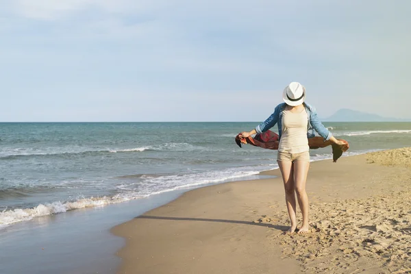 Woman walking away on the idylic beach.