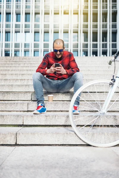 man with mobile phone and bicycle.