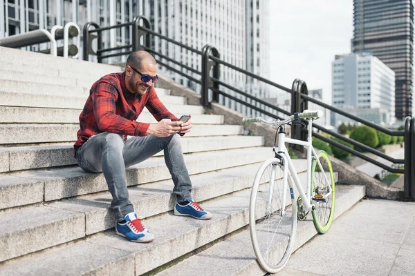 man with mobile phone and bicycle.