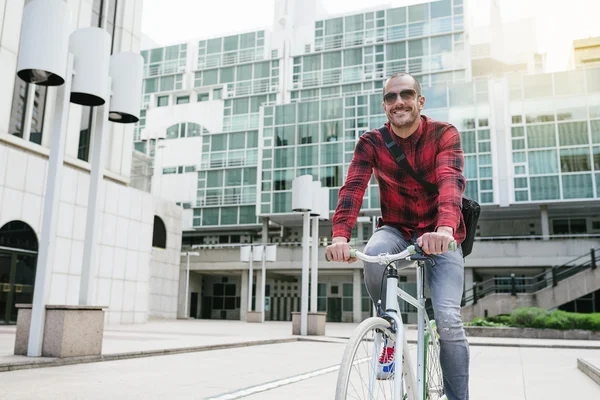 Handsome young man on bike in the city.