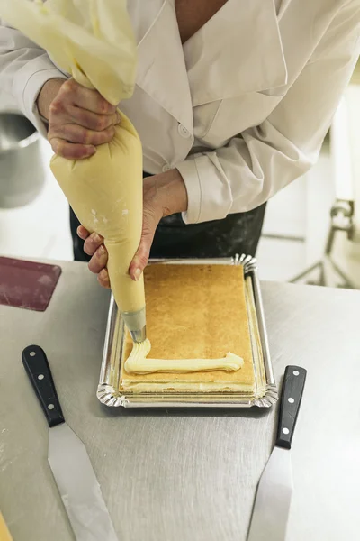 Female pastry chef decorating dessert