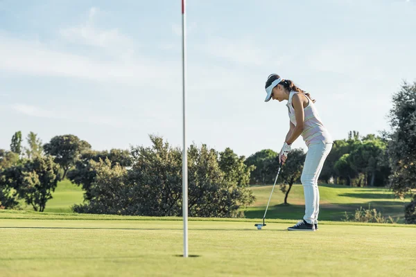 Woman golf player concentrating.