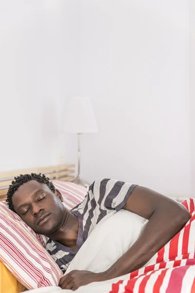 Peaceful african black man sleeping in bed