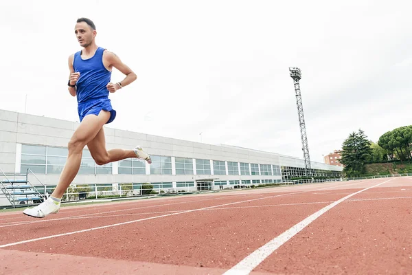 Attractive man Track Athlete Running On Track