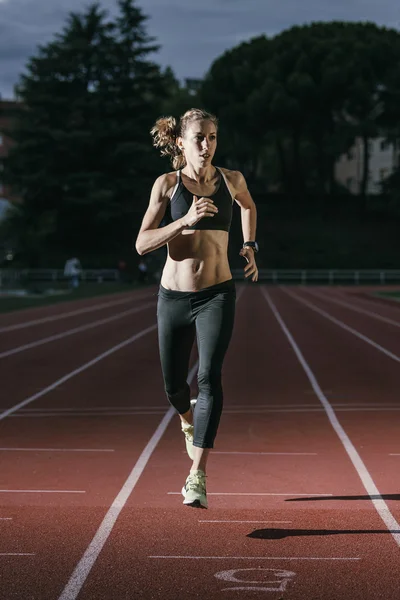 Attractive woman Track Athlete Running On Track