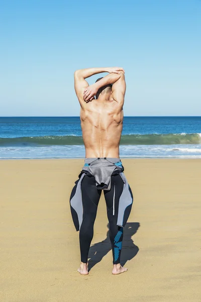 Fitness man swimmer training stretching