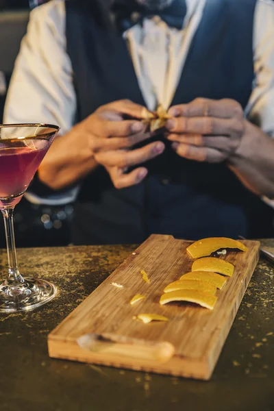 Barman is making cocktail at night club