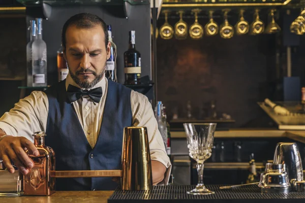 Barman is making cocktail at night club