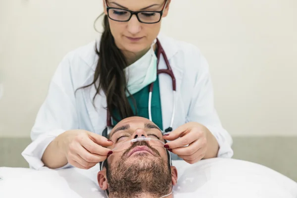 Doctor is caring a sick patient.