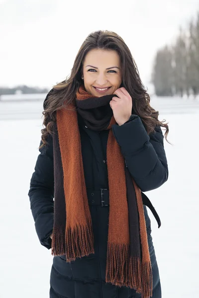 Portrait of smiling young woman in winter park.