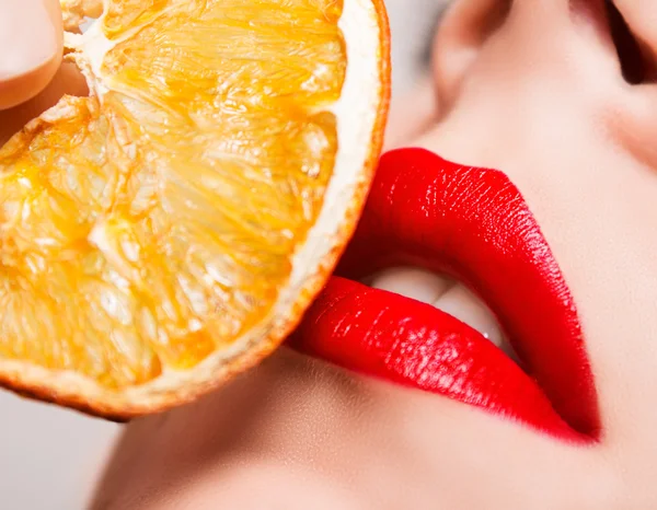Red lips touch the orange