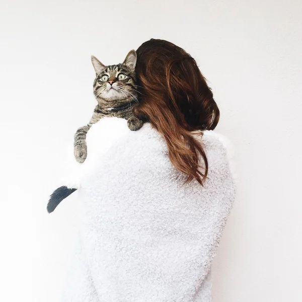 Girl holding funny cat