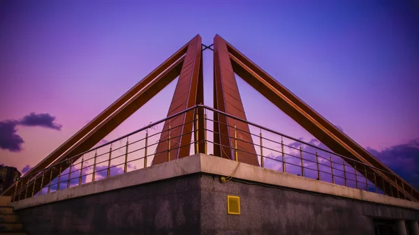 Monument to the teacher against a purple sky