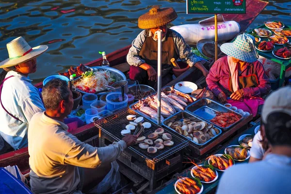 People selling food at floating market