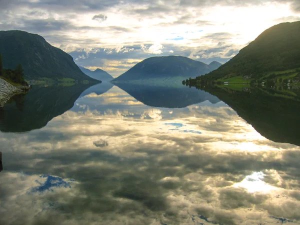 Norwegian fjords with clouds reflection in water