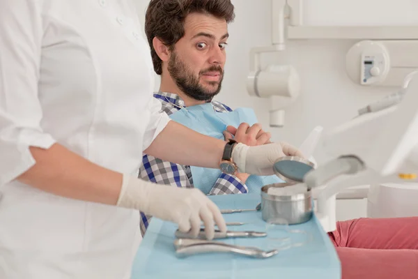 Young man and woman in a dental examination at dentist