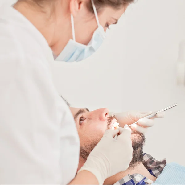 Young happy man and woman in a dental examination at dentist