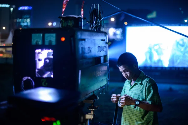 December 13, 2013 - Bangkok Thailand: Staff preparing film for a screening in a temporary outdoor event in Bangkok, Thailand.