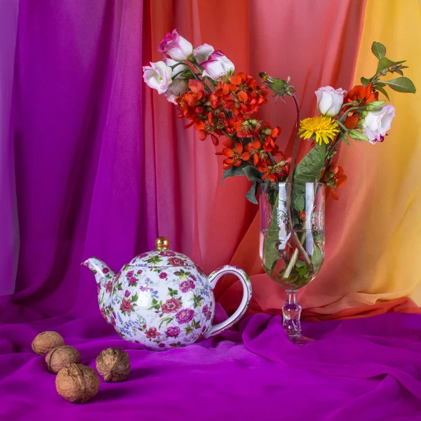 Still life with bouquet summer flowers, teapot and walnuts